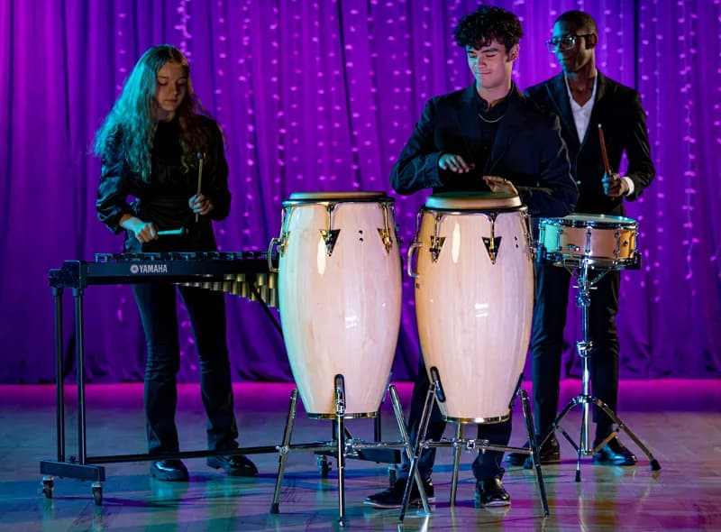 Students Playing drums on stage