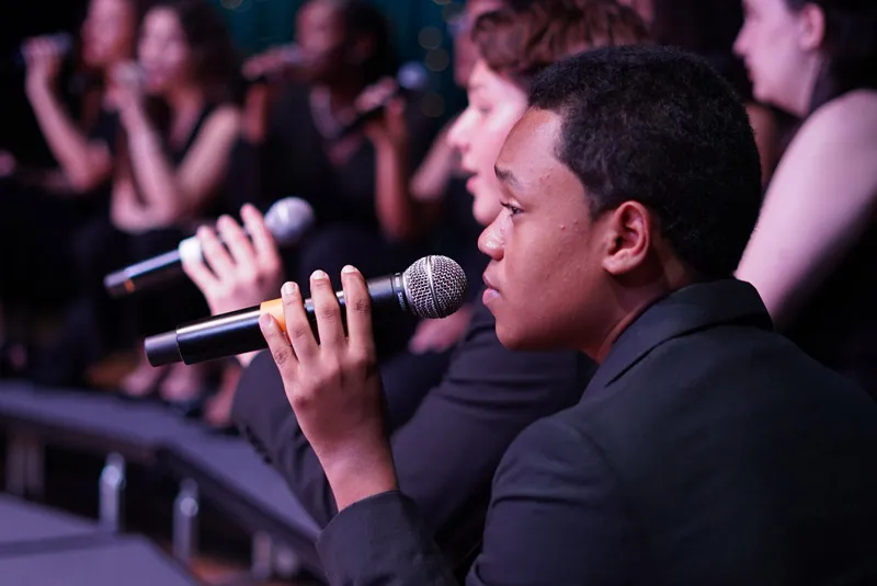 Students singing with a microphones